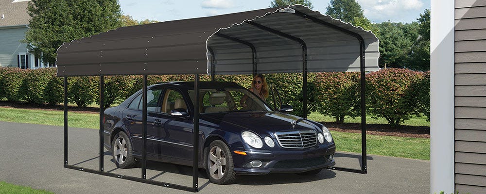 A metal carport kit in a driveway